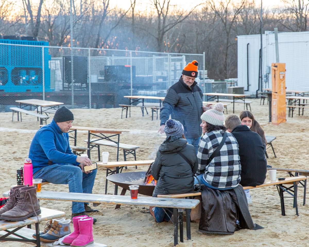 Fifty West Brewing outdoor fire people gathered around 