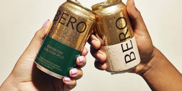 Two BERO beer cans cheersing