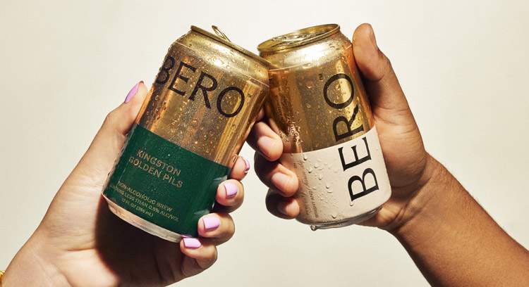 Two BERO beer cans cheersing 